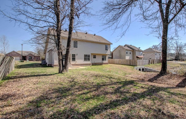 back of property with a patio, fence, a lawn, and central AC