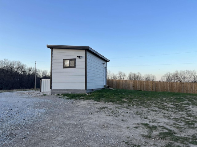 view of outbuilding featuring an outdoor structure and fence