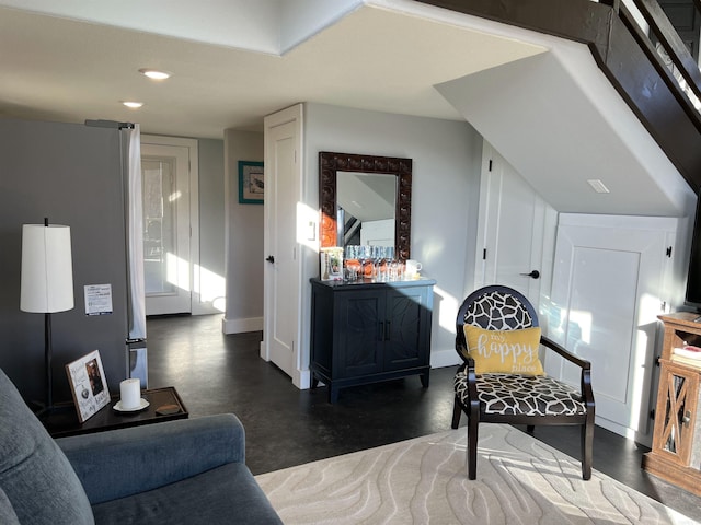 living area with recessed lighting, baseboards, and finished concrete flooring