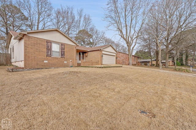 view of front facade with brick siding, a front yard, and a garage