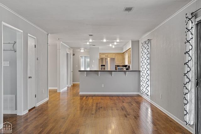 kitchen featuring dark countertops, visible vents, stainless steel appliances, and wood-type flooring