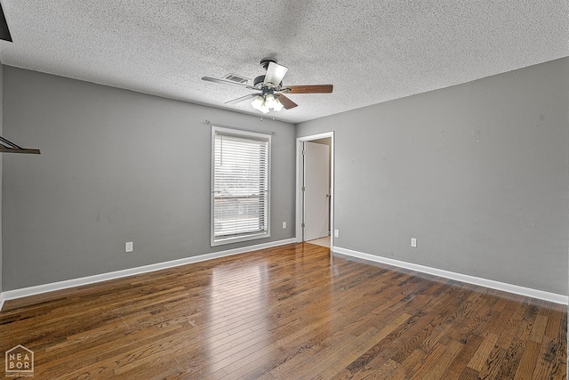 unfurnished room featuring visible vents, baseboards, ceiling fan, wood-type flooring, and a textured ceiling