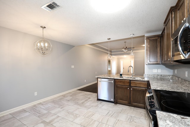 kitchen with visible vents, a sink, dark brown cabinets, appliances with stainless steel finishes, and decorative light fixtures