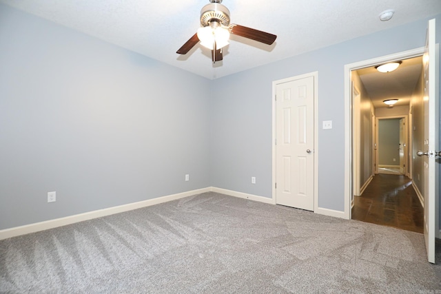 unfurnished bedroom featuring baseboards, carpet floors, and ceiling fan