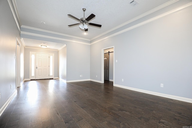 spare room featuring dark wood-type flooring, a ceiling fan, visible vents, and baseboards