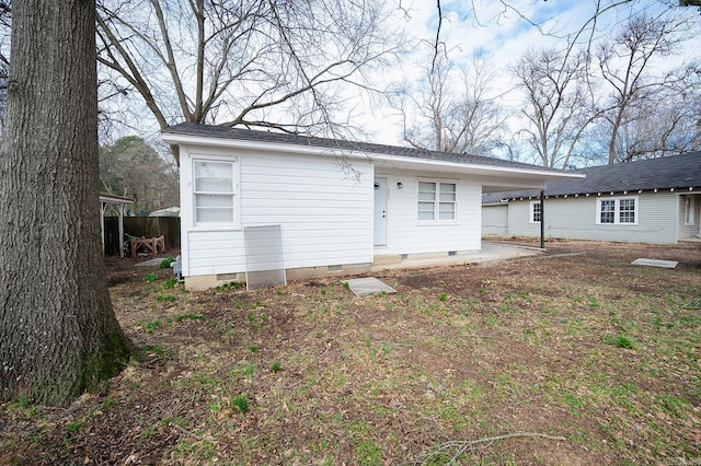 rear view of house featuring a patio area and crawl space