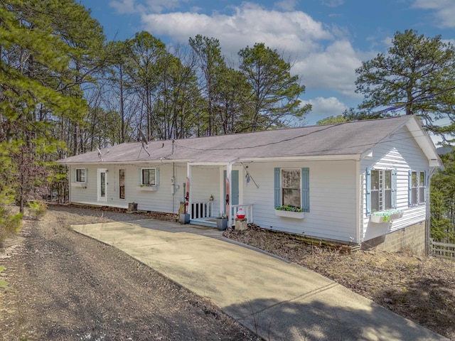 single story home featuring concrete driveway