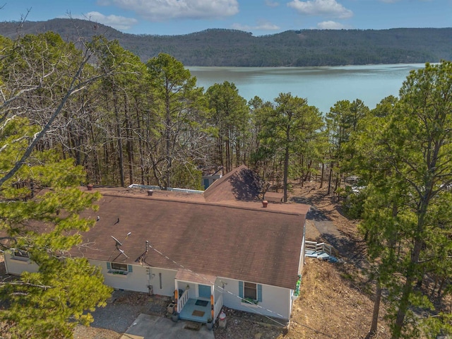 birds eye view of property featuring a water view and a view of trees