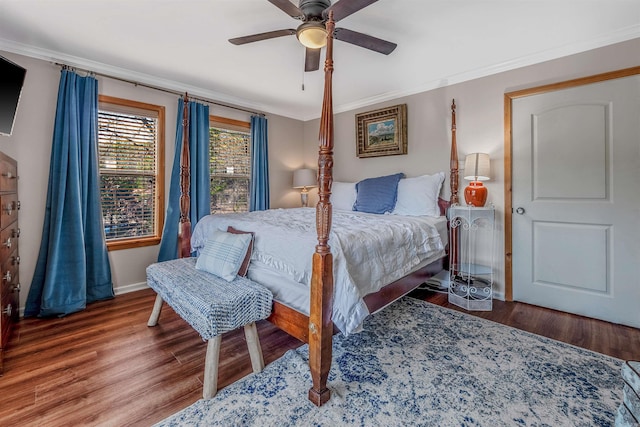 bedroom featuring a ceiling fan, crown molding, baseboards, and wood finished floors