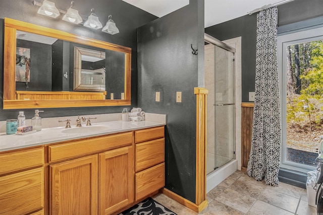 full bath with a shower stall and vanity