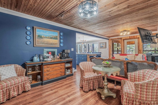 dining area featuring light wood-type flooring, wood ceiling, and ornamental molding