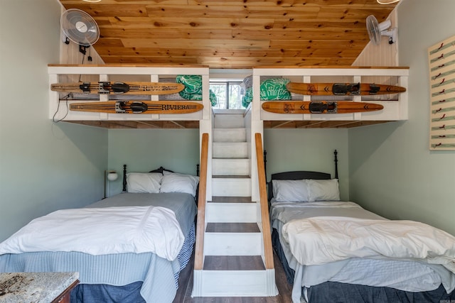 bedroom with wood finished floors, wooden ceiling, and vaulted ceiling