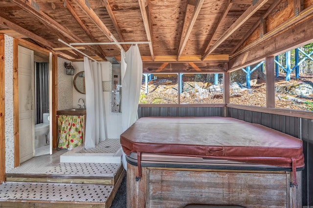 unfurnished sunroom featuring vaulted ceiling