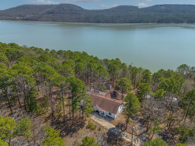 bird's eye view featuring a forest view and a water and mountain view