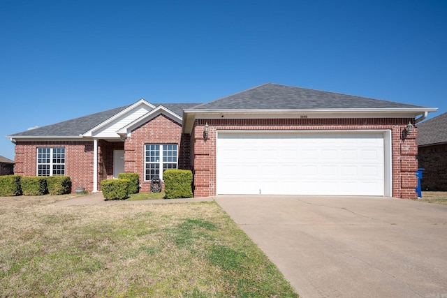 single story home with a front lawn, concrete driveway, an attached garage, a shingled roof, and brick siding