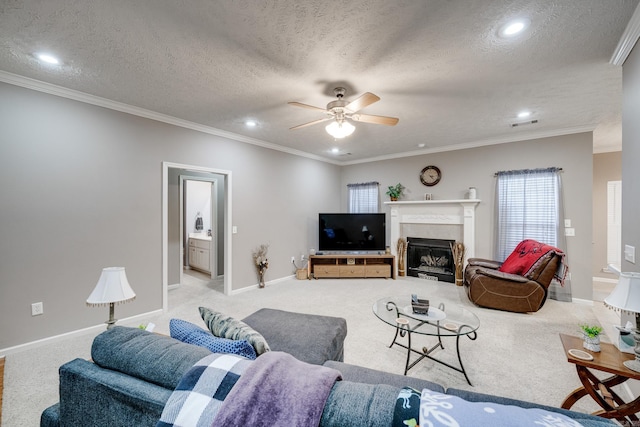 living area with crown molding, baseboards, light carpet, a textured ceiling, and a ceiling fan