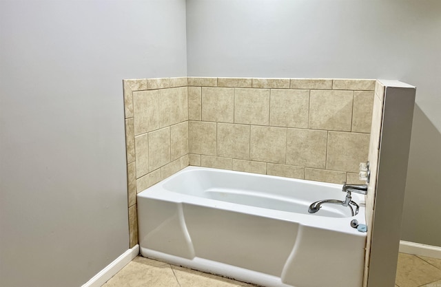 bathroom with tile patterned floors, baseboards, and a garden tub