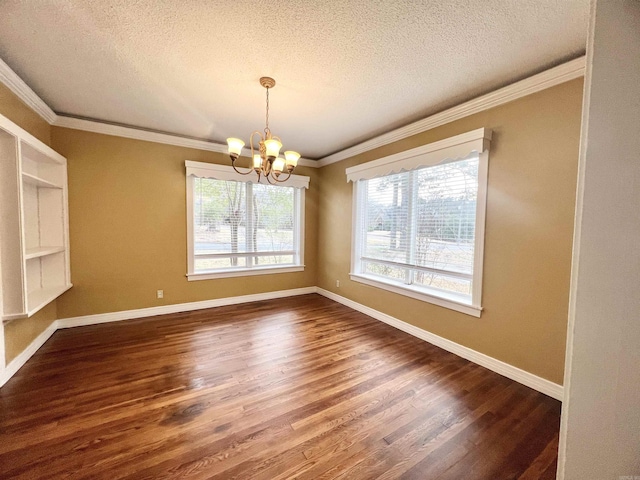 unfurnished room with a notable chandelier, plenty of natural light, ornamental molding, and dark wood-style flooring