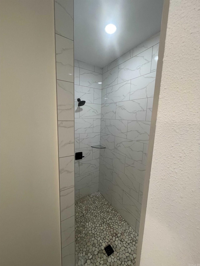 bathroom with tiled shower