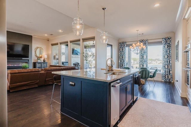 kitchen with a sink, a notable chandelier, plenty of natural light, and dark wood-type flooring