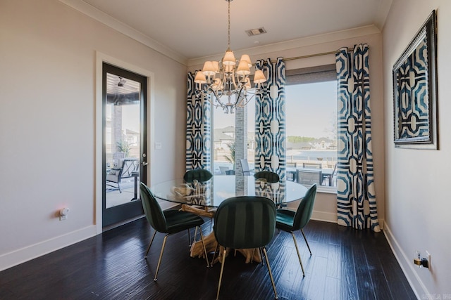 dining room with visible vents, crown molding, baseboards, an inviting chandelier, and wood finished floors