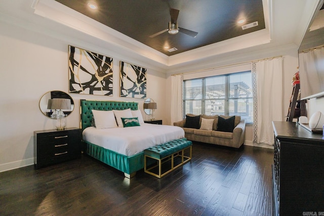 bedroom featuring visible vents, a raised ceiling, and dark wood-style floors