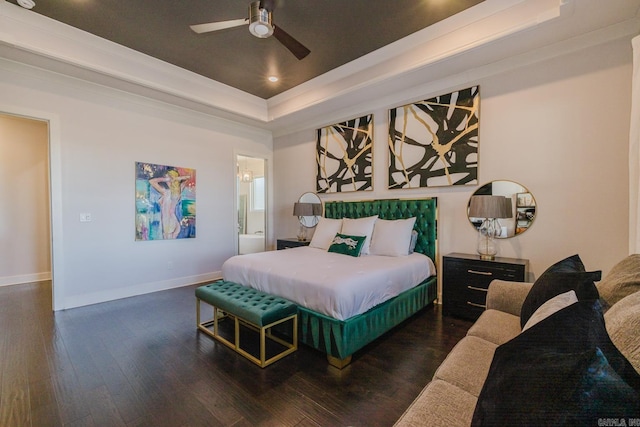 bedroom with a raised ceiling, hardwood / wood-style floors, recessed lighting, connected bathroom, and baseboards