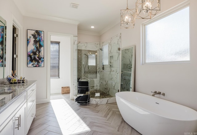 bathroom featuring a freestanding tub, a shower stall, crown molding, a chandelier, and vanity