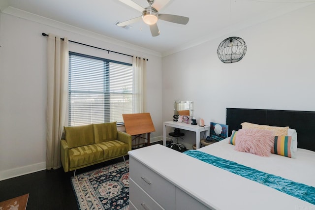 bedroom featuring visible vents, dark wood-type flooring, baseboards, ornamental molding, and a ceiling fan