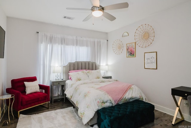 bedroom featuring visible vents, ceiling fan, baseboards, and wood finished floors