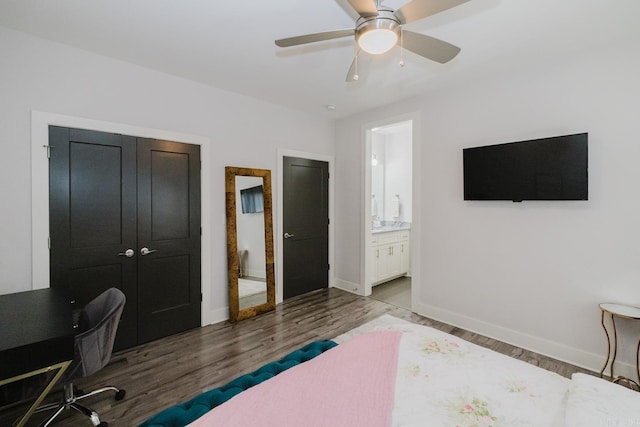 bedroom with a ceiling fan, wood finished floors, baseboards, a closet, and ensuite bathroom