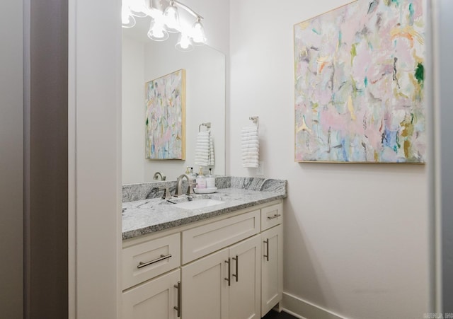 bathroom featuring baseboards and vanity