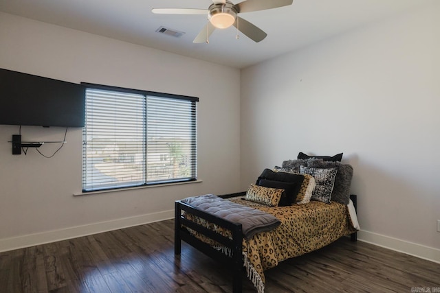 bedroom with visible vents, ceiling fan, baseboards, and wood finished floors