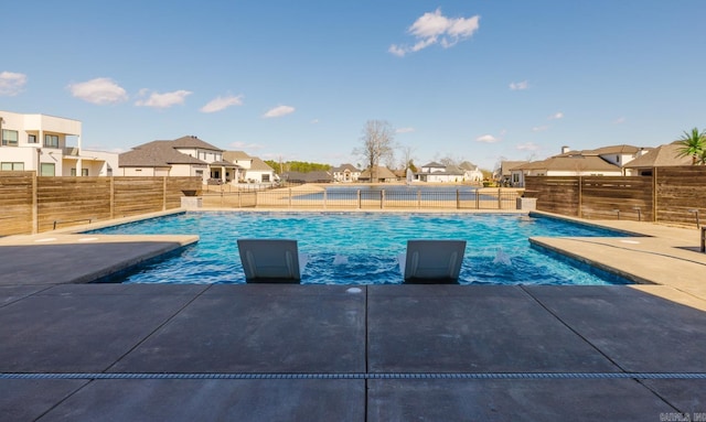 view of pool featuring a residential view, a fenced in pool, a patio, and fence