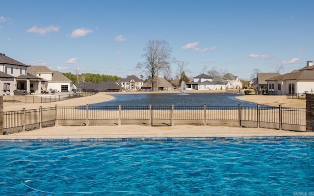 view of pool featuring fence and a residential view