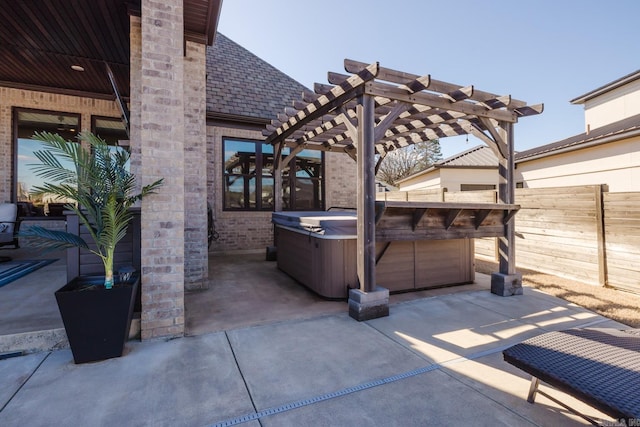 view of patio featuring fence, a pergola, and a hot tub