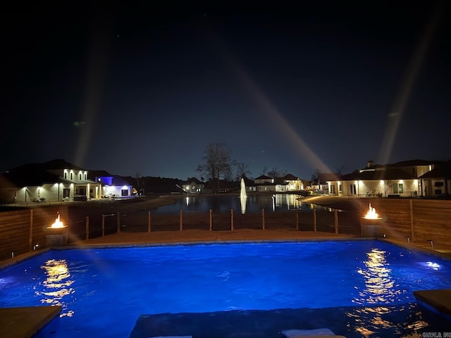 pool at twilight with a fenced in pool and a fenced backyard