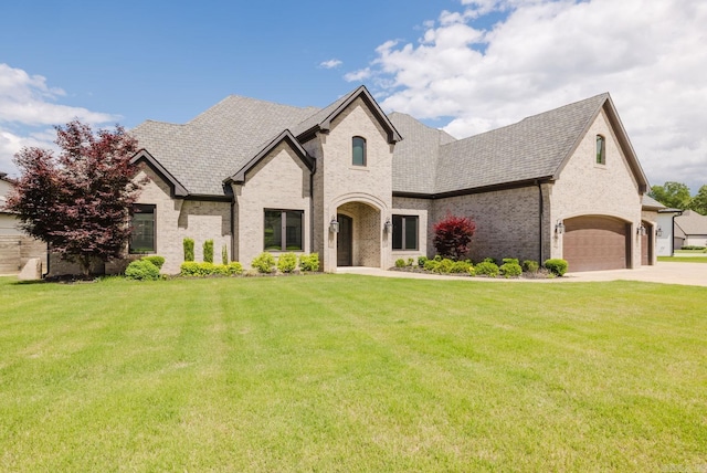 6745 Hilo Ave, Benton, AR 72019 - french provincial home with brick siding, a front lawn, concrete driveway, and roof with shingles