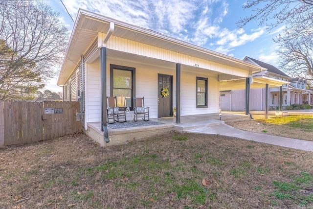 view of front facade featuring a porch and fence