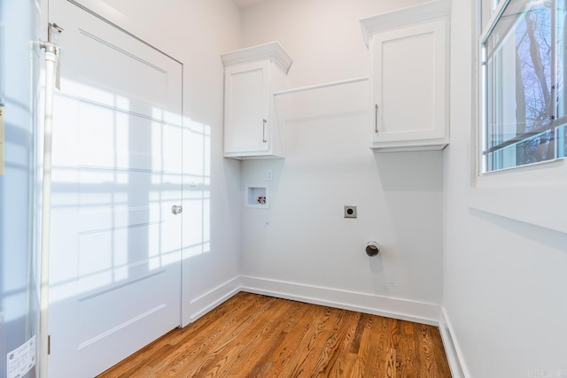 laundry area featuring baseboards, washer hookup, light wood-style floors, cabinet space, and electric dryer hookup