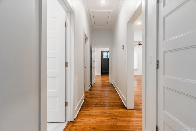 hallway with baseboards, recessed lighting, attic access, and light wood-style floors