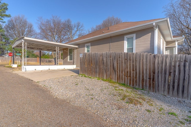 view of side of home with fence