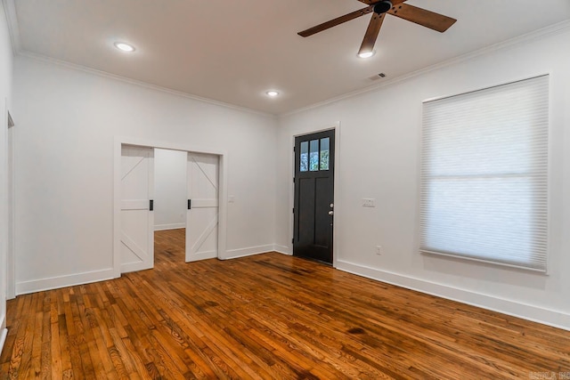 foyer featuring crown molding, a ceiling fan, and wood-type flooring