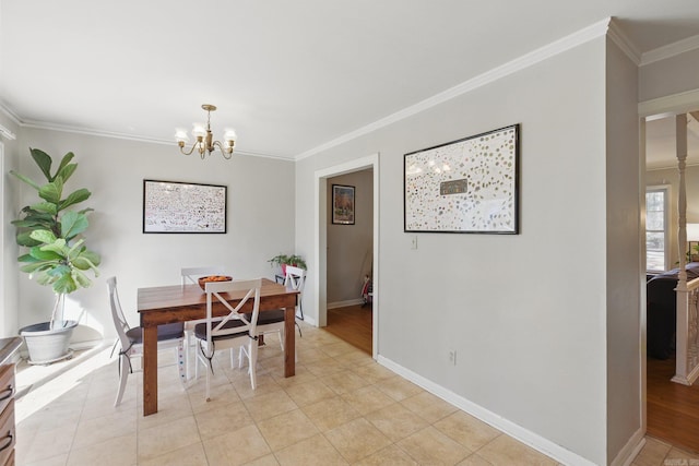 dining area with light tile patterned floors, baseboards, a notable chandelier, and ornamental molding