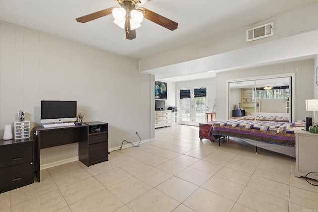 bedroom with visible vents, baseboards, light tile patterned flooring, and a ceiling fan