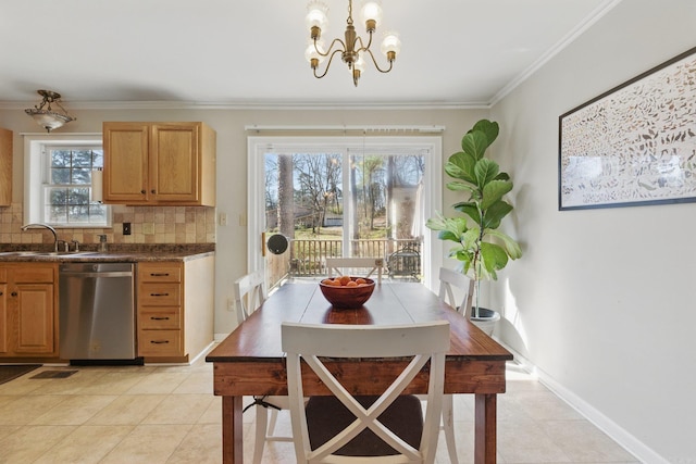 dining area featuring a wealth of natural light, baseboards, a chandelier, and crown molding