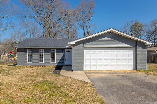 ranch-style home featuring a front yard, brick siding, an attached garage, and driveway