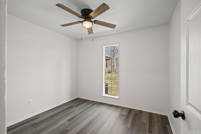 empty room with ceiling fan, baseboards, and dark wood-style flooring