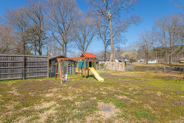 view of yard featuring fence and a playground