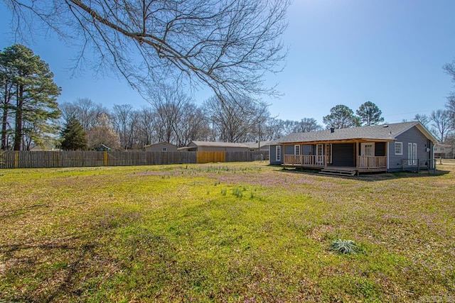 view of yard with a wooden deck and fence